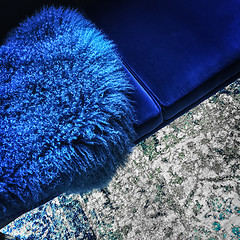 Image showing Blue sheep skin decorating a velvet sofa