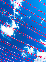 Image showing Pink balls decoration against blue sky and clouds