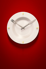 Image showing a dish clock on red background