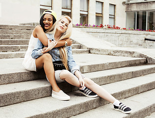 Image showing Two teenage girls infront of university building smiling, having