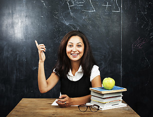 Image showing portrait of happy cute real teen student in classroom at blackboard close up, lifestyle education people concept close up