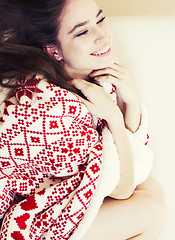 Image showing young pretty brunette girl in Christmas ornament blanket getting