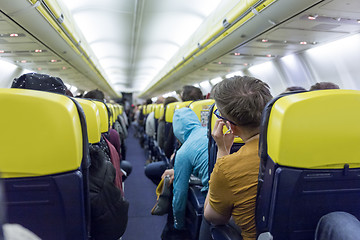 Image showing Interior of commercial airplane during flight.