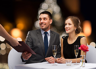 Image showing couple taking menu at christmas restaurant
