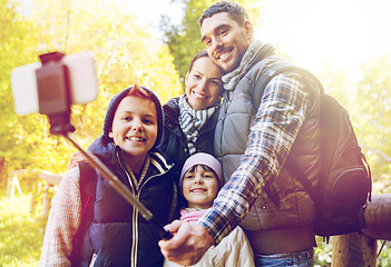 Image showing family with backpacks taking selfie and hiking