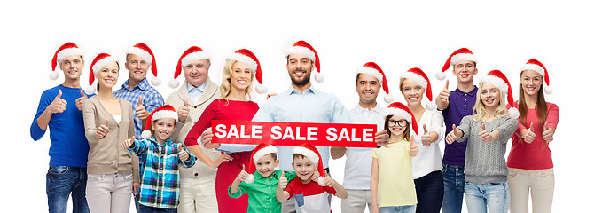 Image showing people in santa hats with sale sign at christmas