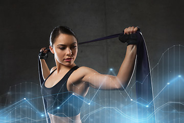 Image showing woman with expander exercising in gym