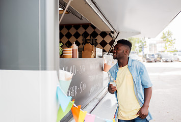 Image showing african american man with drink at food truck