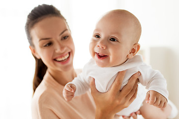 Image showing happy mother playing with little baby boy at home