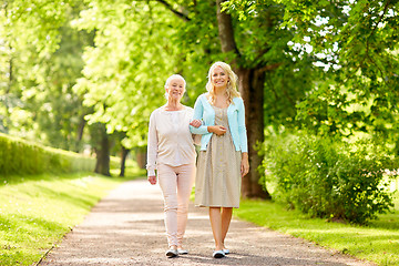 Image showing daughter with senior mother walking at summer park