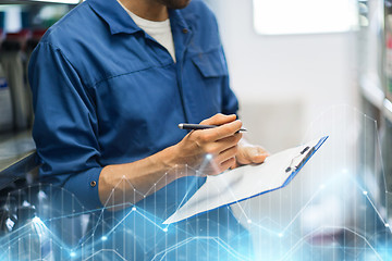 Image showing auto mechanic with clipboard at car workshop