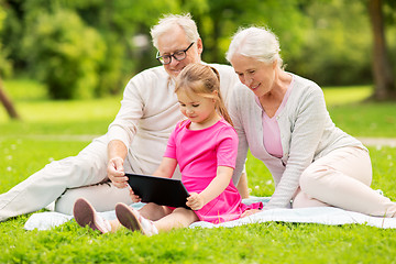 Image showing grandparents and granddaughter with tablet pc