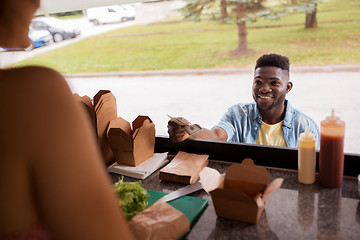 Image showing african american man buying wok at food truck