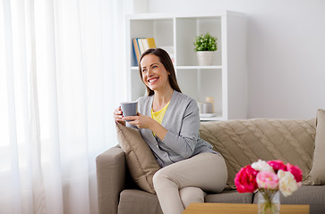 Image showing happy woman drinking tea or coffee at home