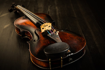 Image showing Old violin in vintage style on wood background