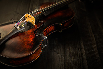 Image showing Old violin in vintage style on wood background