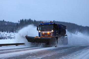 Image showing Snowplow Clears Road in Evening Snowfall