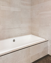 Image showing New bathroom with ceramic tile walls in beige tones