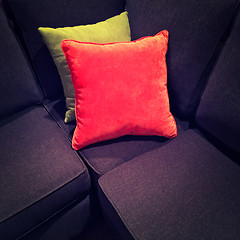 Image showing Bright velvet cushions on a dark sofa