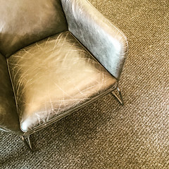 Image showing Gray leather armchair on carpet floor