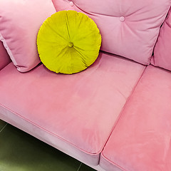 Image showing Pink velvet sofa with fancy green cushion