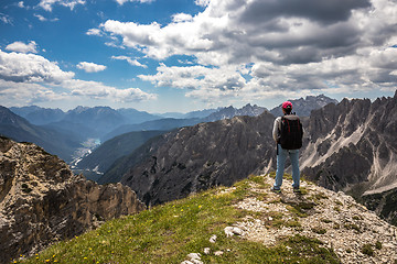 Image showing Hiker woman standing up achieving the top Dolomites Alps.