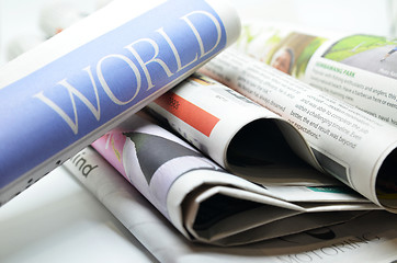 Image showing Rolled newspaper with the world news