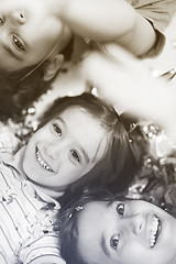 Image showing kids  blowing confetti while lying on the floor