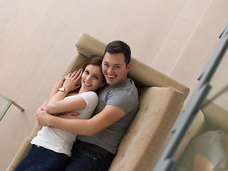 Image showing young handsome couple hugging on the sofa