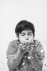 Image showing kid blowing confetti