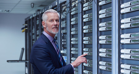 Image showing Senior businessman in server room