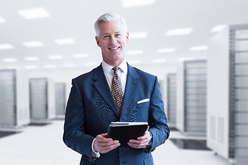 Image showing Senior businessman in server room