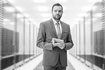 Image showing Young businessman in server room