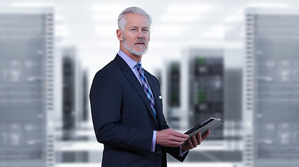 Image showing Senior businessman in server room