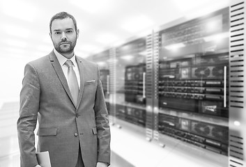 Image showing Young businessman in server room