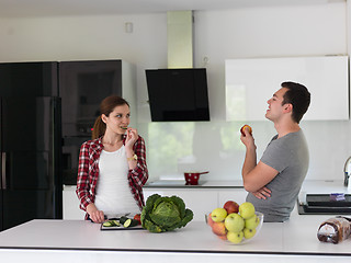 Image showing Young handsome couple in the kitchen