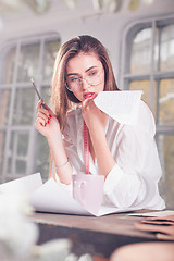 Image showing Fashion designers working in studio sitting on the desk