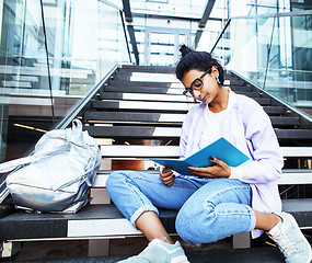 Image showing young cute indian girl at university building sitting on stairs 