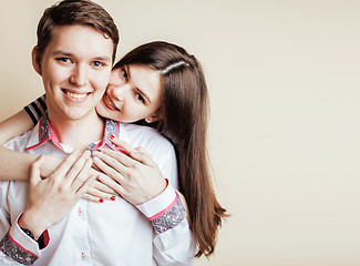 Image showing couple of happy smiling teenagers students, warm colors having a kiss, lifestyle people concept, boy and girl together