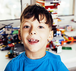 Image showing little cute preschooler boy playing lego toys at home happy smiling, lifestyle children concept 