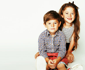 Image showing little cute boy and girl hugging playing on white background, ha