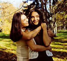 Image showing mature mother with daughter outside hugging in park