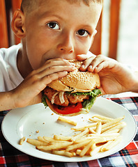 Image showing little cute boy 6 years old with hamburger and french fries maki
