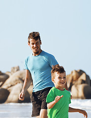 Image showing happy family on beach playing, father with son walking sea coast, rocks behind smiling enjoy summer