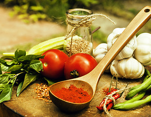 Image showing vegetables on wooden kitchen with spicies, tomato, chilli, green