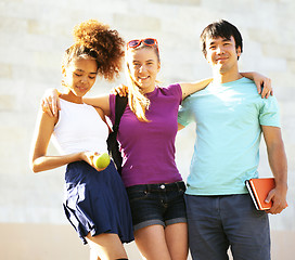 Image showing cute group of teenages at the building of university with books 