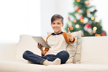 Image showing boy with tablet pc showing thumbs up at christmas