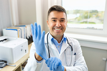 Image showing smiling doctor with protective gloves at clinic