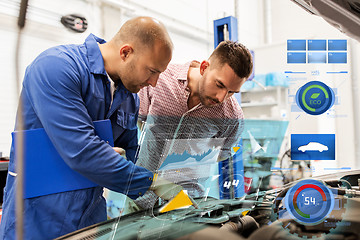 Image showing auto mechanic with clipboard and man at car shop