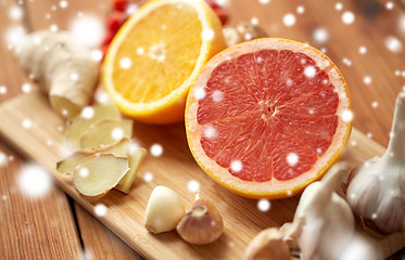 Image showing citrus, ginger, garlic and rowanberry on wood